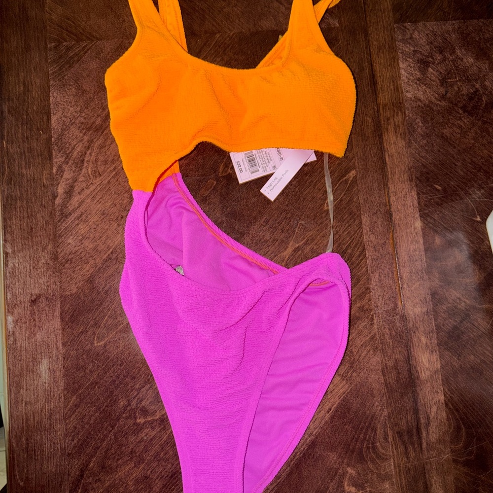 bright Wild Fable orange and pink one piece swimsuit, never worn w/ tags.